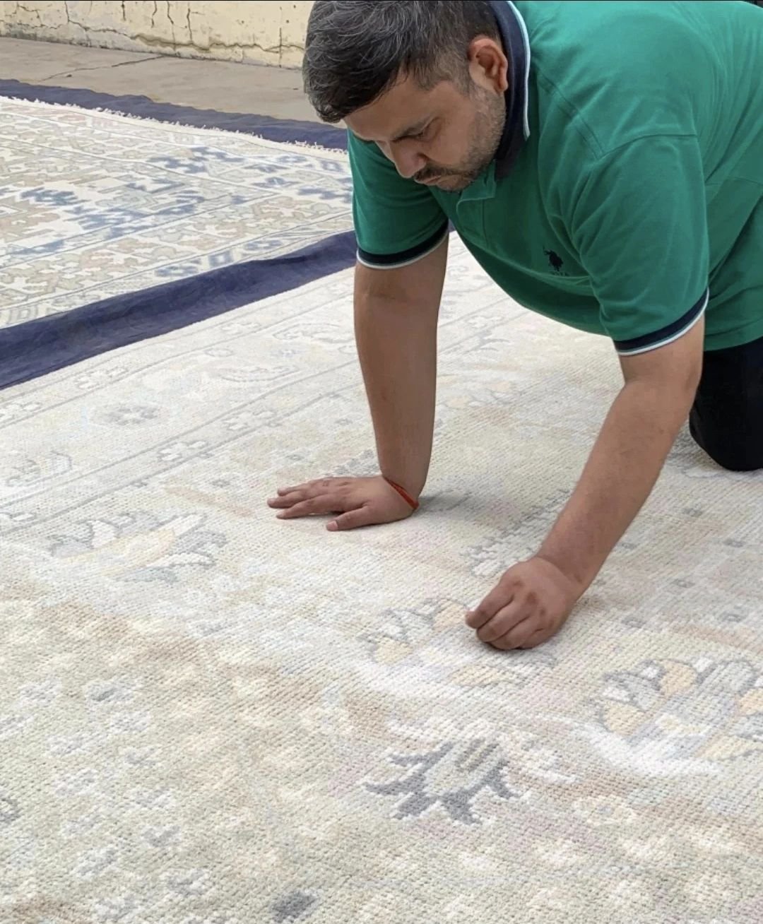 Master Artisan Inspecting Hand-Knotted Rug Quality at Shukla Brothers Workshop